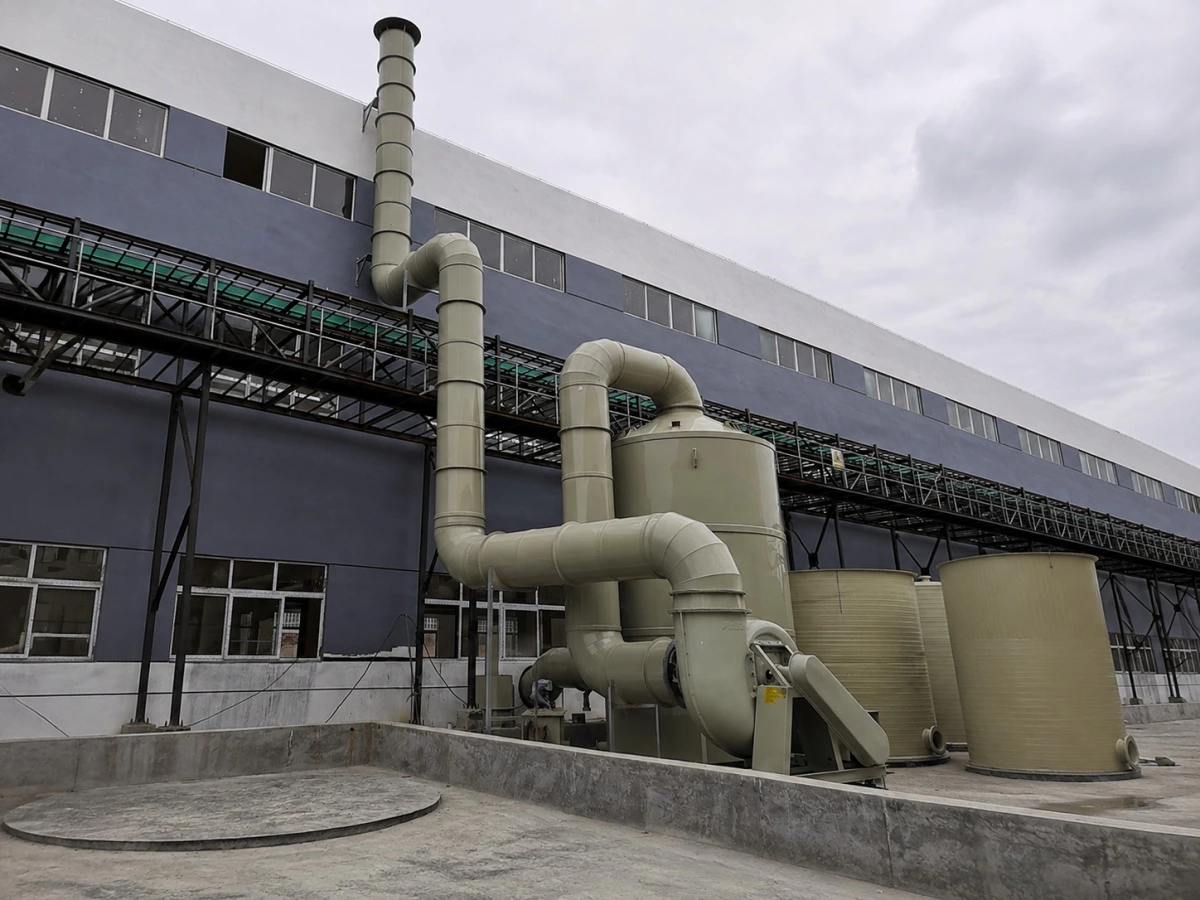 PP wet scrubber tower connected to ductwork and an FRP exhaust fan