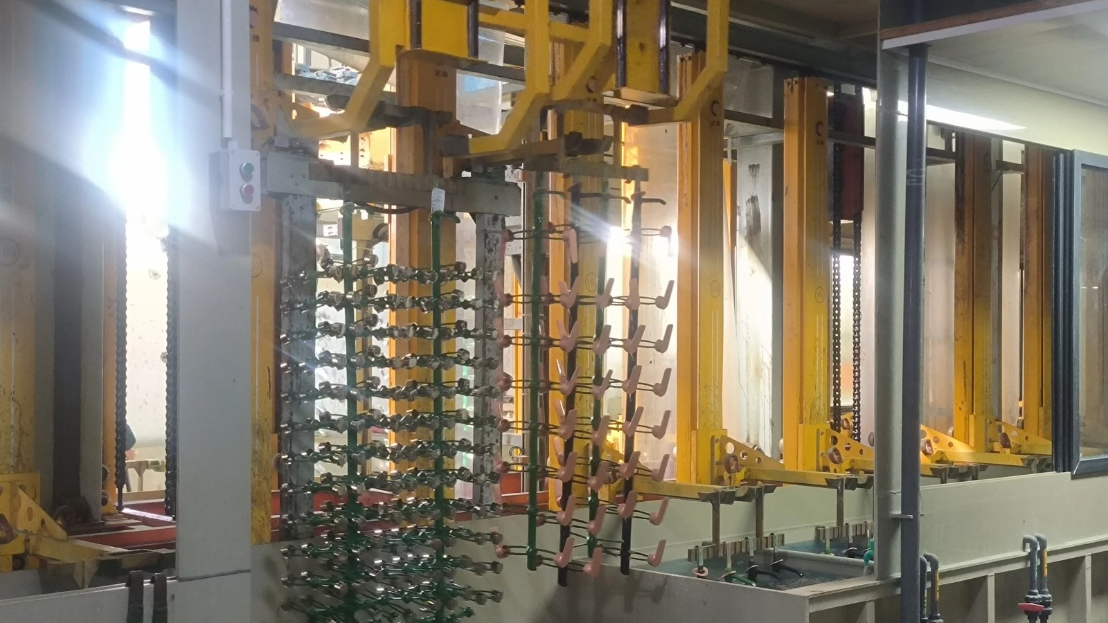 Rack electroplating line with lifting mechanisms and workpiece racks