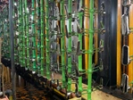 Hardware components suspended on electroplating racks