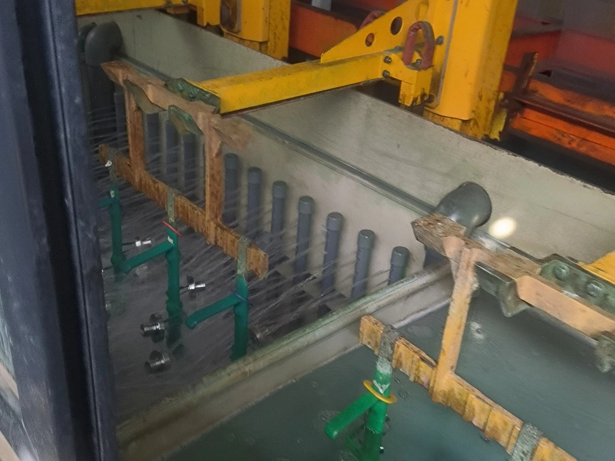 Rack carrier and lifting assembly above an electroplating process tank